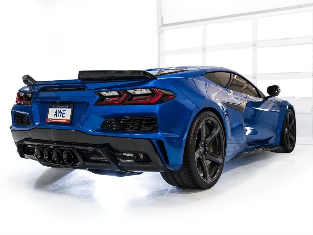 Close-up of quad 4.5-inch diamond black tips on AWE SwitchPath Exhaust for C8 Corvette Z06, highlighting polished finish against a white background