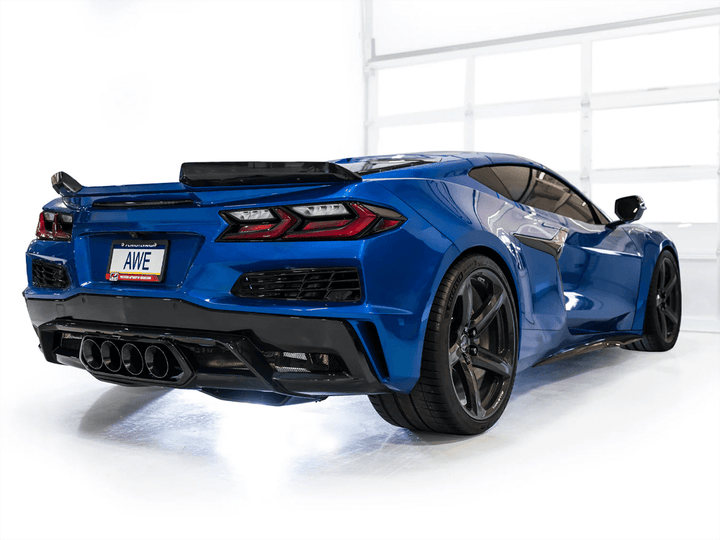 Close-up of quad 4.5-inch diamond black tips on AWE SwitchPath Exhaust for C8 Corvette Z06, highlighting polished finish against a white background