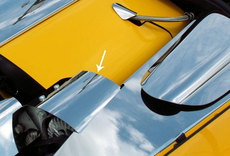 ACC 043033 polished alternator cover installed beside yellow C6 engine trim