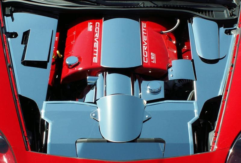 ACC 043033 alternator cover among polished trim in a red C6 engine bay