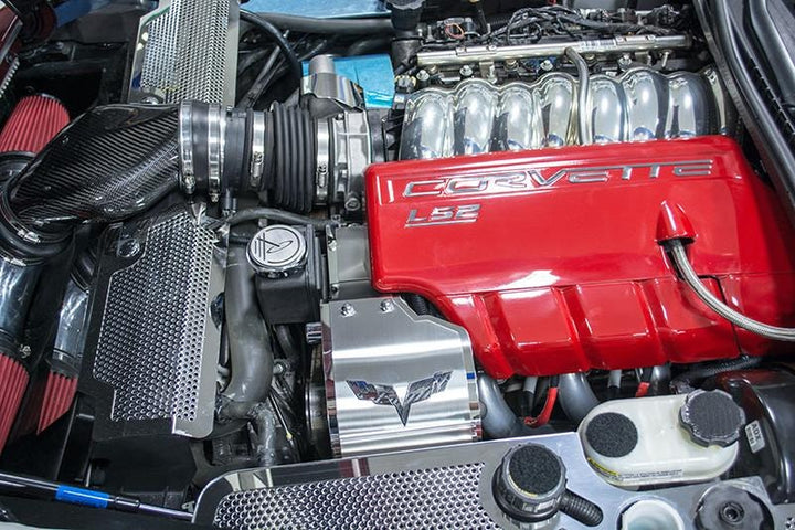 ACC 043122 deluxe cover beside red LS2 engine trim in a C6 Corvette