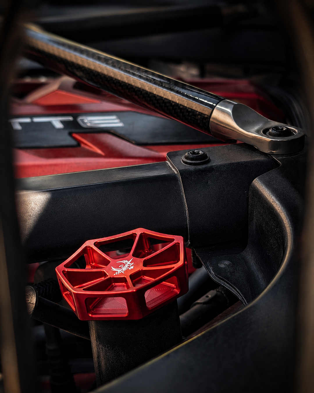 Red AMT Overkill oil cap installed beside the engine cover in a C8 Corvette