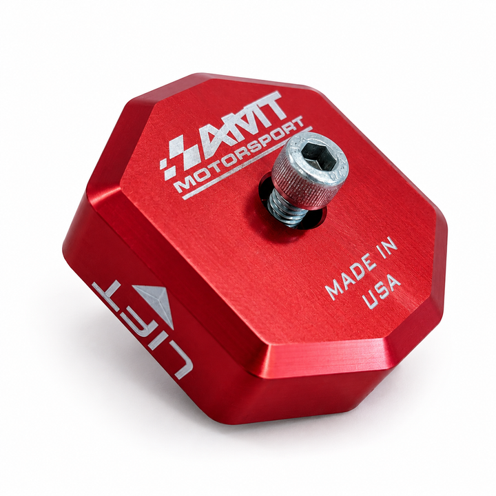 Red anodized AMT Switchblade jacking puck showing its center screw, engraved AMT logo, LIFT marking and machined aluminum face