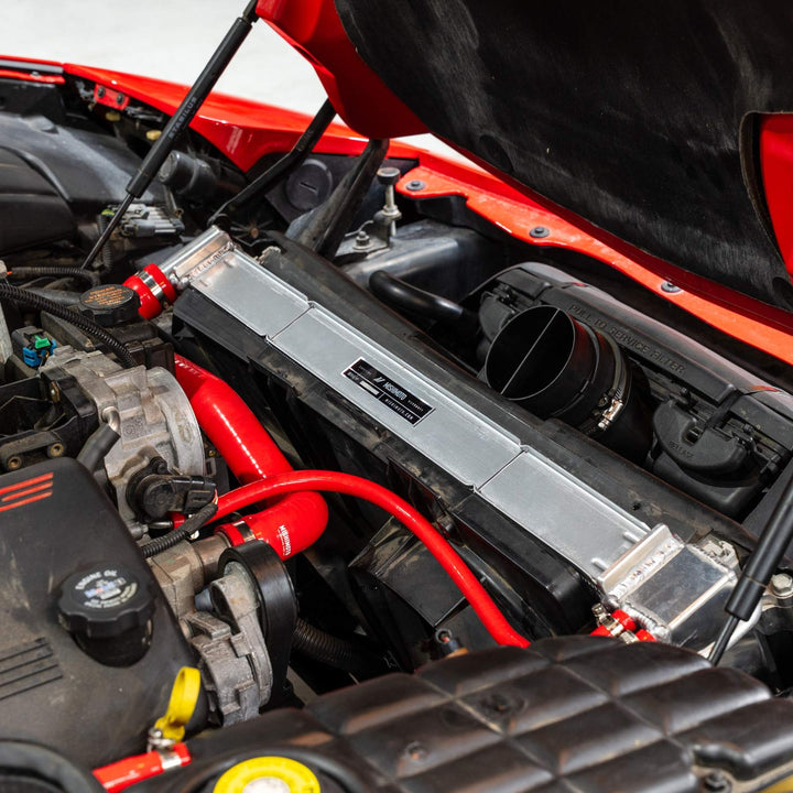Mishimoto MMRAD-C5-97 radiator installed in a C5 Corvette; red silicone hoses sold separately