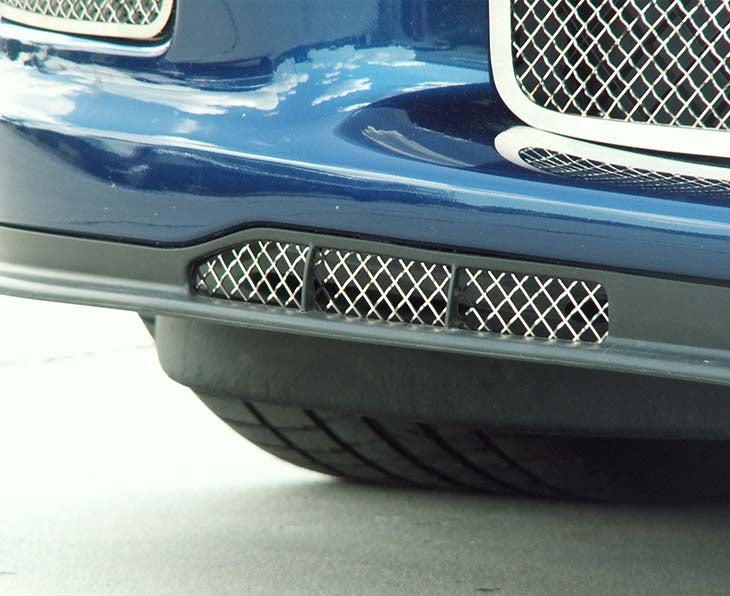 American Car Craft 042045 polished Laser Mesh grille in a C6 Corvette lower air-dam opening, close-up