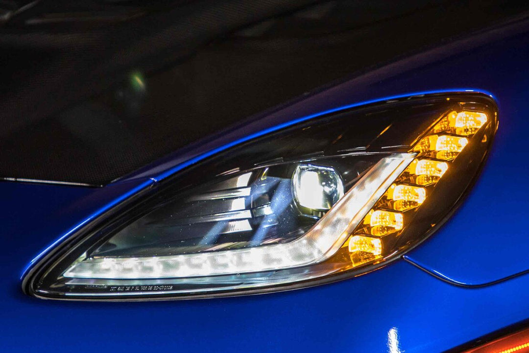 Close-up three-quarter view of Morimoto XB Gen I LED headlights installed on a C6 Corvette