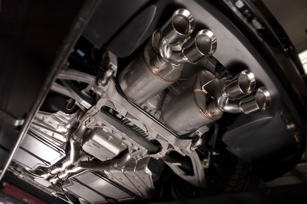 Under car view of Stainless Works 2.5-inch axle-back connection at factory slip joint on a C6 Corvette