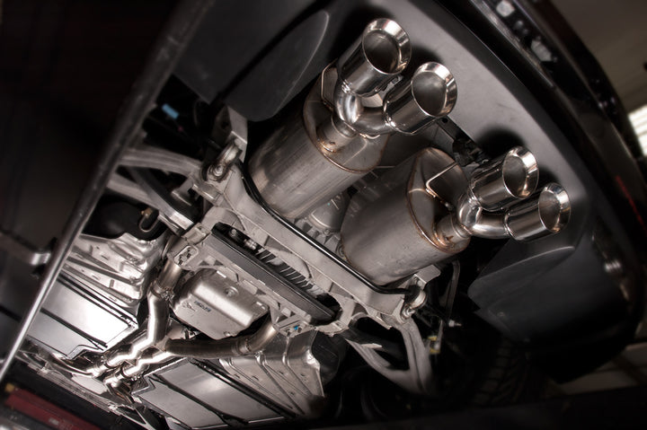 Under car view of Stainless Works 2.5-inch axle-back connection at factory slip joint on a C6 Corvette