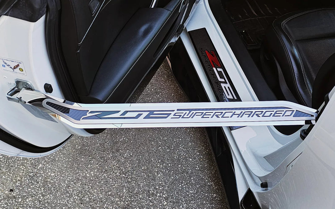 Close-up of the Z06 Supercharged driver-side door prop installed on a C7 Corvette