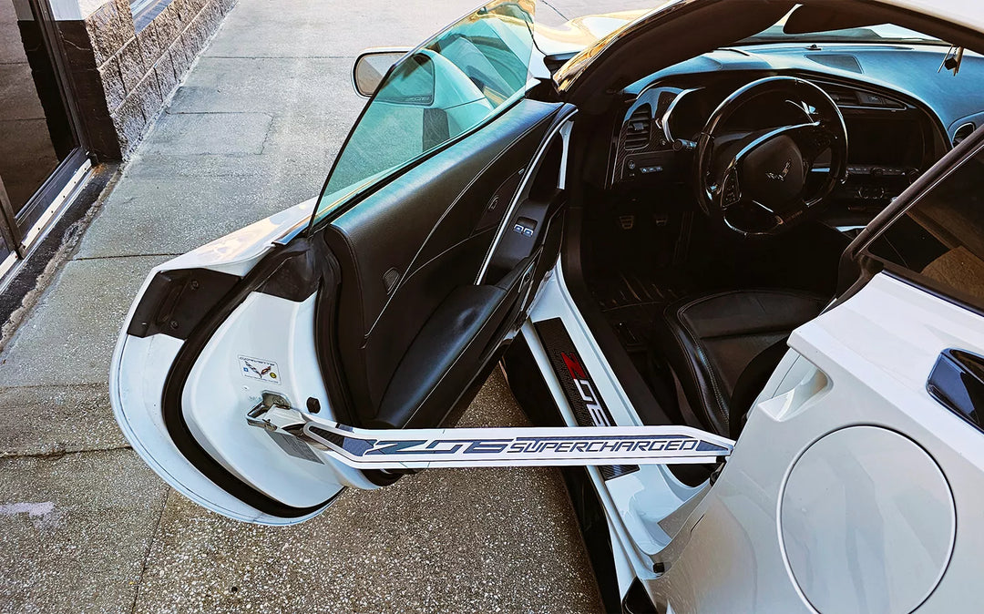 Driver-side American Car Craft door prop installed on a C7 Corvette Z06; driver side shown