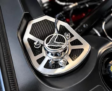 ACC 883071 carbon-fiber shock-tower insert with brushed stainless trim and a crossed-flag cap fitted to a later C8 Corvette Coupe