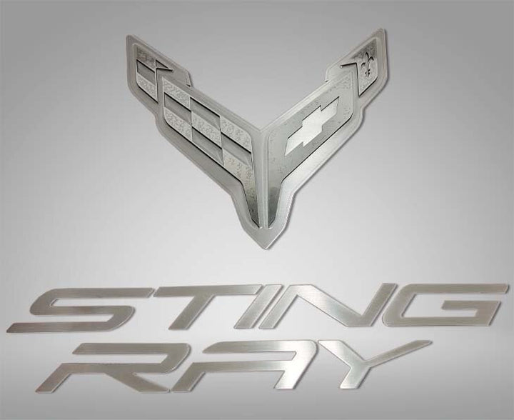 ACC 883051 crossed-flags and Stingray lettering badge components for a C8 Corvette hood panel.