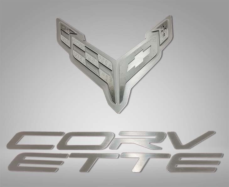 ACC 883052 crossed-flags and Corvette lettering badge components for a C8 Corvette hood panel.