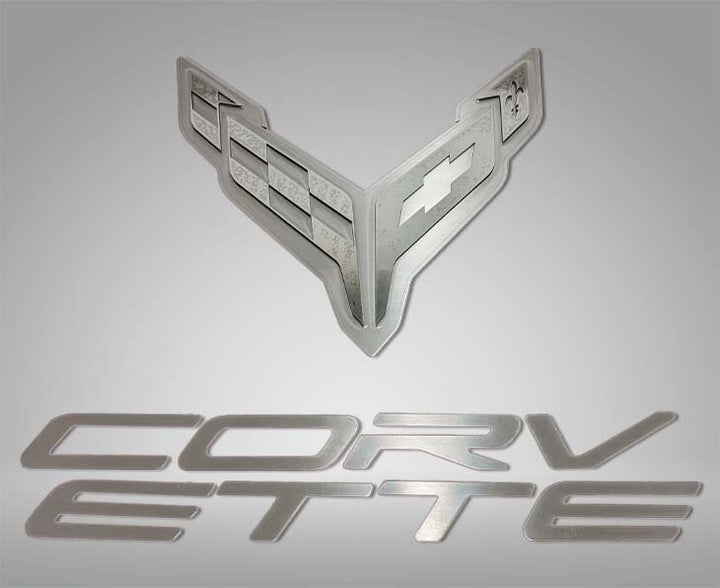 ACC 883052 crossed-flags and Corvette lettering badge components for a C8 Corvette hood panel.