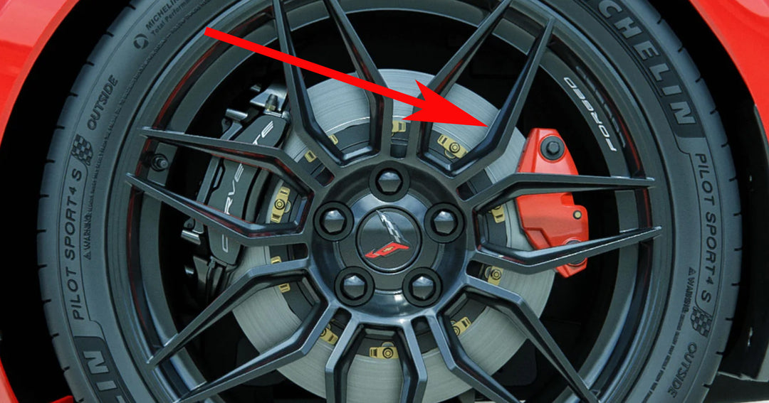 C8 Corvette rear wheel showing the red emergency-brake caliper cover beside the main brake caliper.