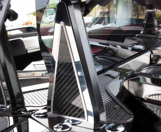 Close view of the carbon-fiber insert and polished stainless edging on a C8 Corvette Coupe engine-hatch hinge dress-up piece