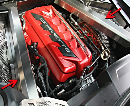Brushed stainless rear crossmember covers installed around a C8 Corvette Coupe engine, with arrows showing the two decorative covers