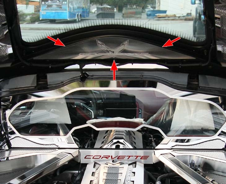 Arrows identify the brushed stainless rear vanity plate with etched Corvette logo beneath the open hatch of a C8 Corvette Coupe