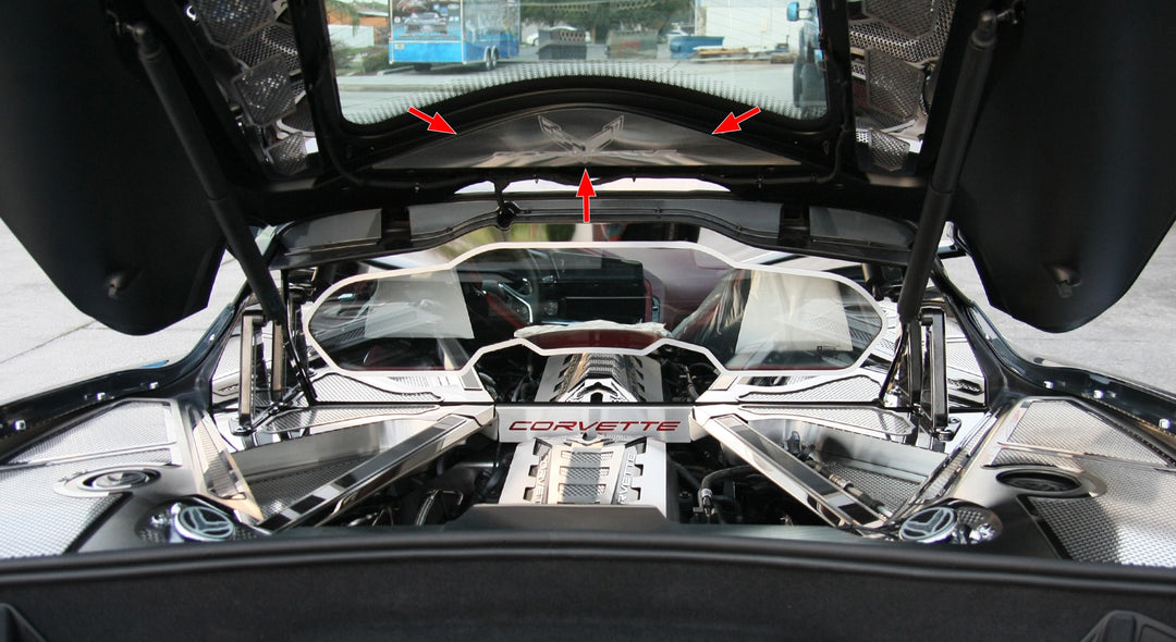 C8 Corvette Coupe with the rear hatch open, showing the etched-logo vanity plate above the engine bay and separate dress-up accessories