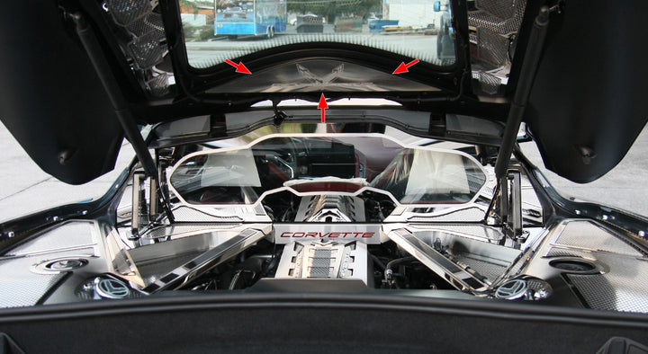 C8 Corvette Coupe with the rear hatch open, showing the etched-logo vanity plate above the engine bay and separate dress-up accessories