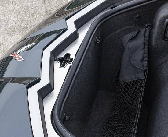 Angled view of the ACC-881013 frunk latch plate around the latch opening on a C8 Corvette Coupe