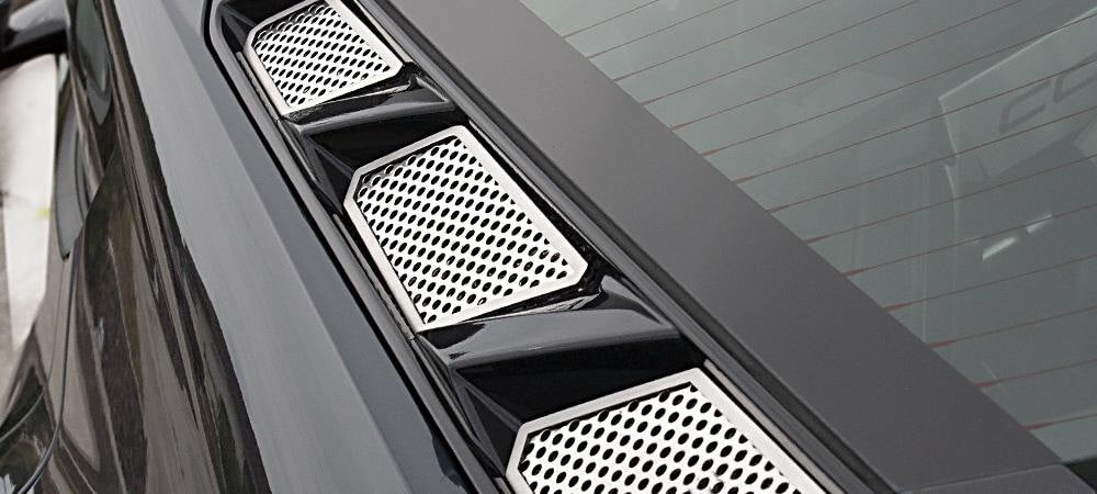 Close view of three polished perforated ACC-882013 inserts along one side of the C8 Corvette Coupe rear hood window