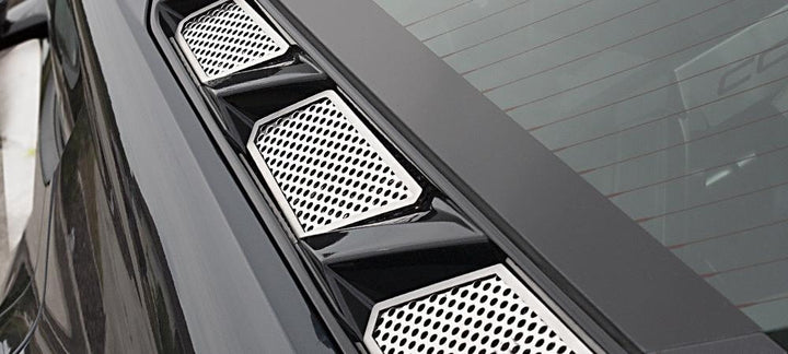 Close view of three polished perforated ACC-882013 inserts along one side of the C8 Corvette Coupe rear hood window