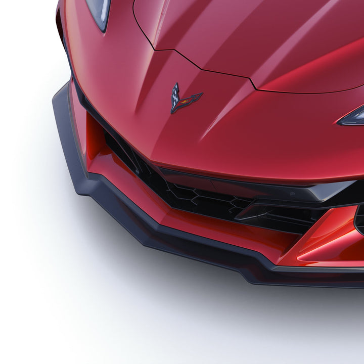 Overhead 3/4 close-up of ACS Composite Z07 splitter on C8 Corvette E-Ray, showing Carbon Flash finish and precise fitment lines.