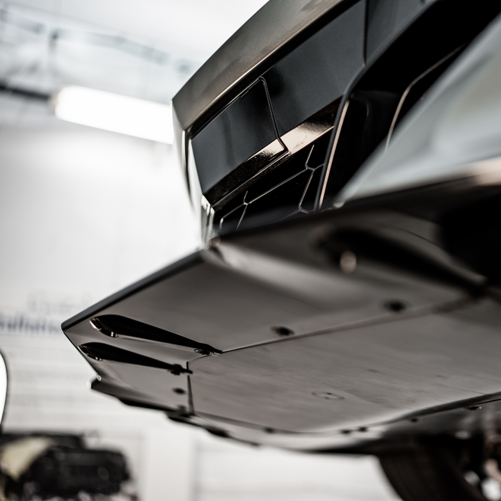 Underside view of ACS Composite Z07 front splitter installed on 2024–2026 C8 Corvette E-Ray, highlighting OEM mounting points and rigidity.