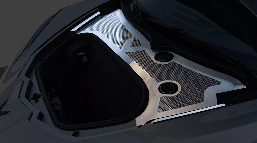 Angled view of ACC front wiper-cowl trim with brushed stainless framing and a polished perforated insert around the C8 front compartment
