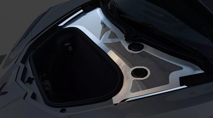 Angled view of ACC front wiper-cowl trim with brushed stainless framing and a polished perforated insert around the C8 front compartment