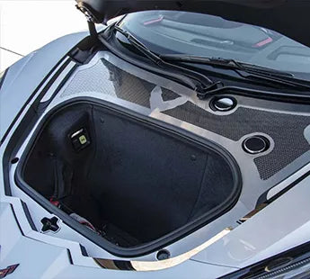 Brushed stainless front wiper-cowl trim with a polished perforated insert behind a C8 Corvette front trunk opening; other trim is separate