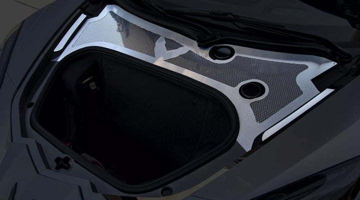 Upper view of the brushed and polished perforated ACC front cowl accent fitted behind the open front trunk on a C8 Corvette Coupe
