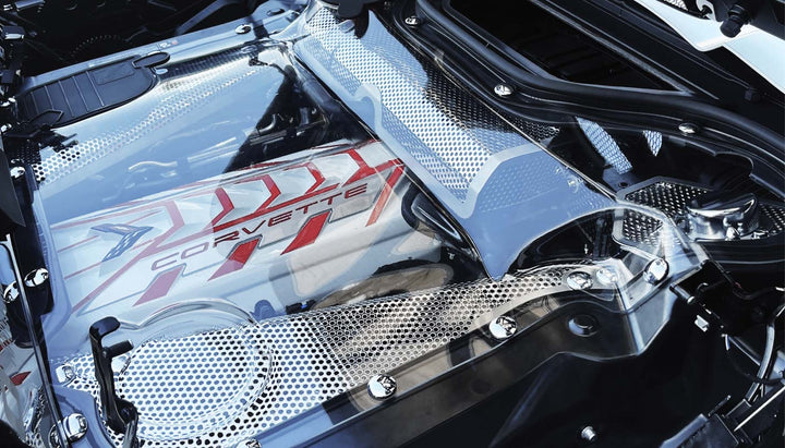 Chrome bolt caps along the opposite side of a C8 convertible engine compartment
