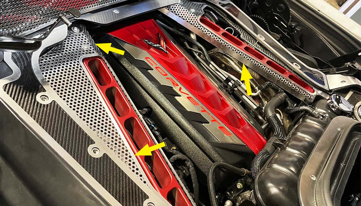 Exposed-crossmember cover locations marked by arrows in a C8 hardtop convertible engine bay