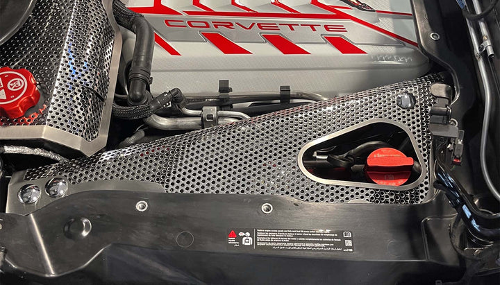 Close-up of the C8 convertible stainless crossmember cover with an access opening