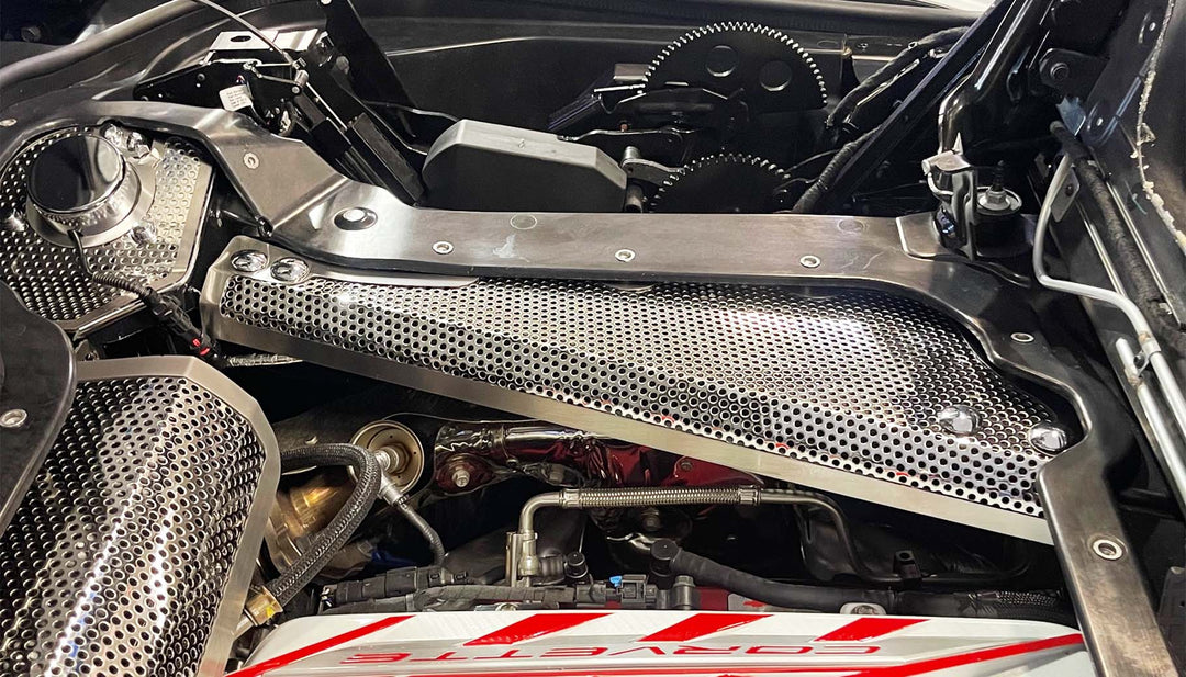 Opposite-side perforated stainless crossmember cover installed in a C8 hardtop convertible