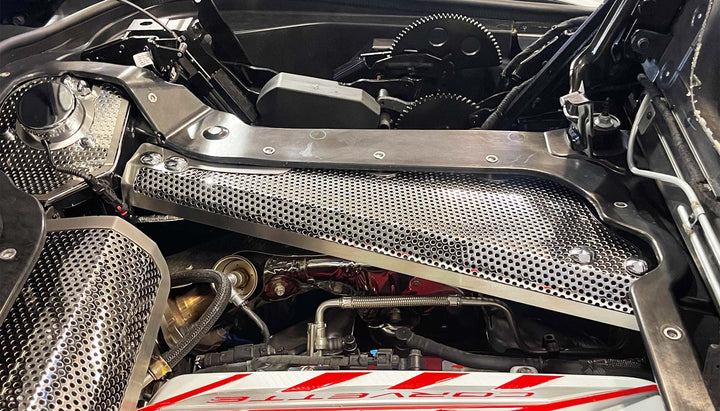 Opposite-side perforated stainless crossmember cover installed in a C8 hardtop convertible