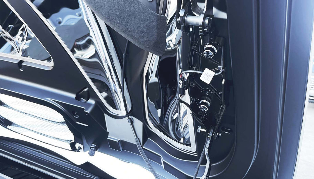 C8 Corvette HTC hinge fastener covers shown from beneath the open hinge assembly