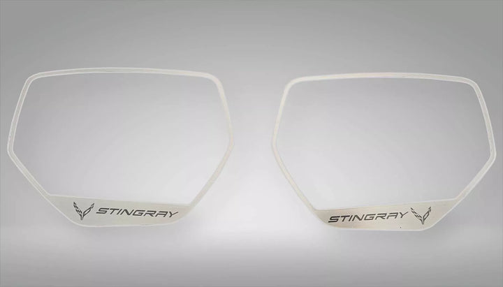 Two brushed stainless side-mirror trim frames with STINGRAY lettering and C8 logos