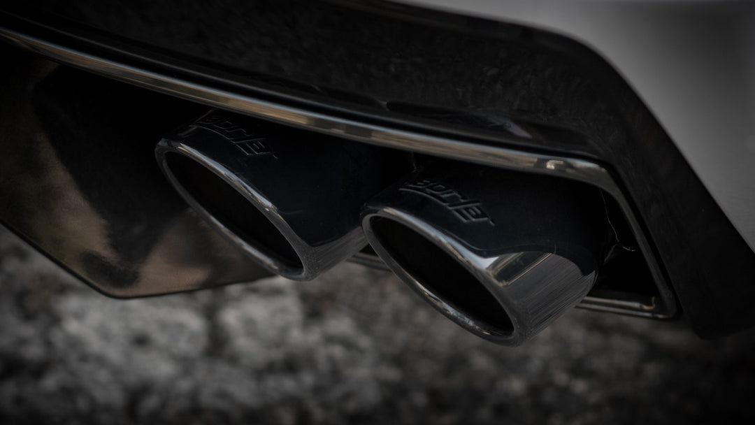 Close-up of Borla 140838BC 4 inch round black chrome tips on C8 Corvette Stingray