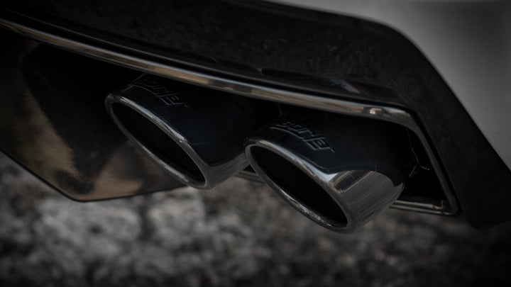 Close-up of Borla 140838BC 4 inch round black chrome tips on C8 Corvette Stingray