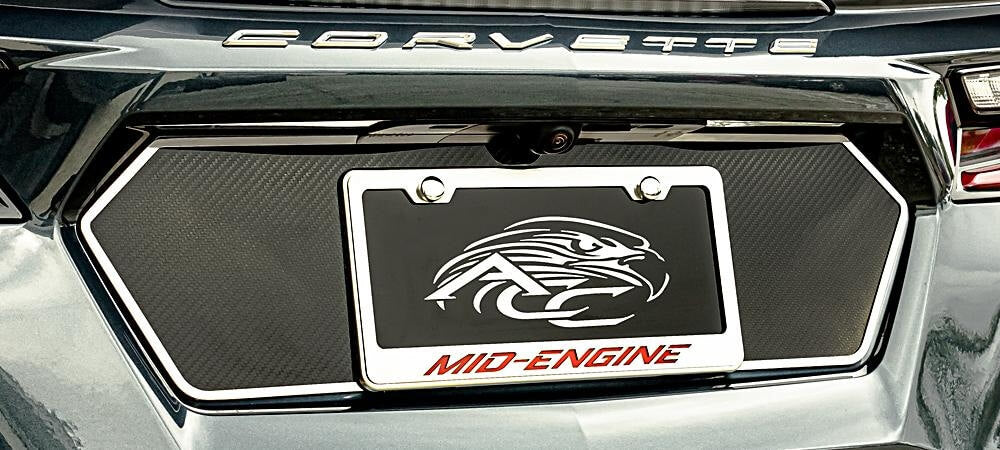 Brushed-trim carbon-fiber tag-back plate fitted around a C8 Corvette license-plate recess, with a separate frame shown