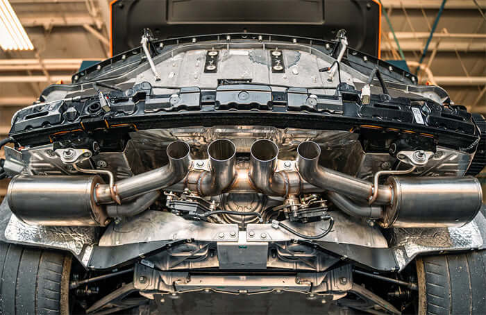 Underbody installation view of CORSA 21111 valved cat-back exhaust on C8 Corvette Z06 showing valve assemblies and 3" stainless tubing