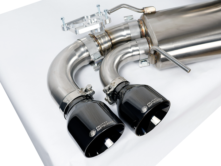 Driver side muffler and outlet of the AutoSpeed cat-back with black chrome tips, on a studio table