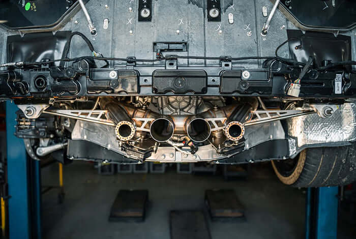 Underbody installation view of CORSA 21113 cat-back exhaust on C8 Corvette Z06 showing valve assemblies and stainless steel tubing
