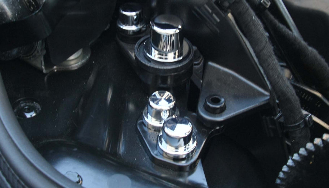 Chrome hinge fastener covers installed over C8 Corvette HTC hinge nuts and bolts