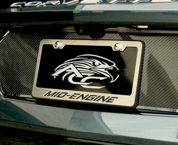 MID-ENGINE license frame with black lettering and black perimeter installed on a C8 Corvette