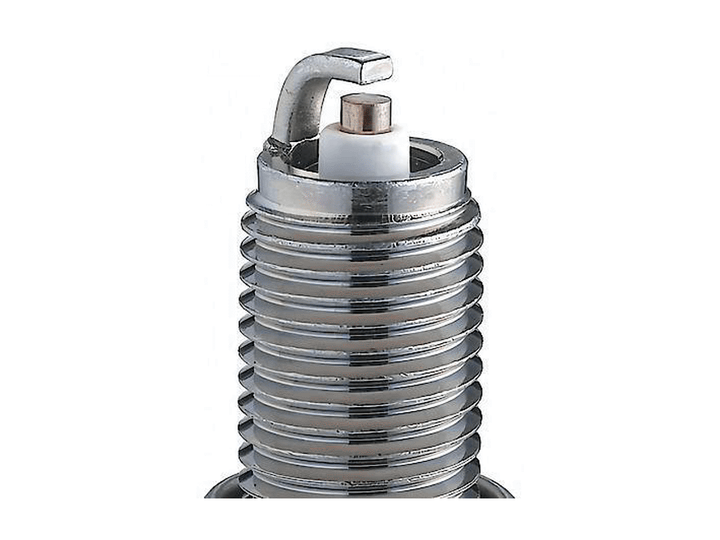 NGK V-Power spark plug firing-end close-up showing the center electrode, ceramic nose, curved ground electrode and threaded shell
